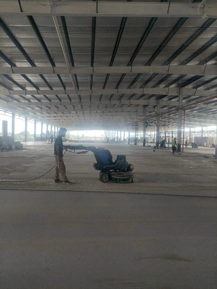 Hasil jasa epoxy lantai industri: permukaan beton halus mengkilap setelah aplikasi sistem pelapis di area gudang.